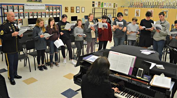 Rustin High School choir students perform with Sergeant Wright from the US Army Field Band 